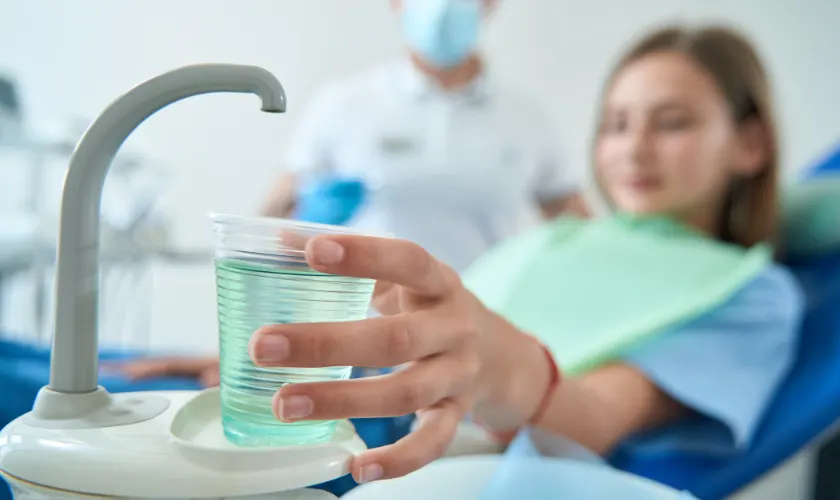 Dentist Howell patient rinsing during a checkup at Riverpark Dental of Howell in cold and flu season