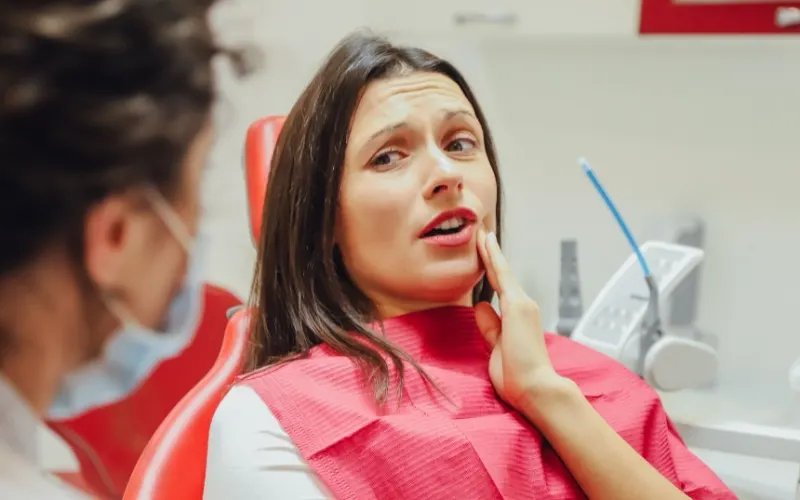 Dentist Howell patient describing cold-sensitive teeth during a winter exam at Riverpark Dental of Howell